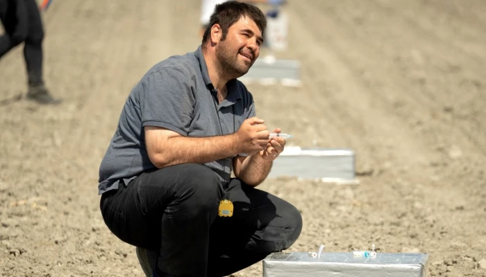 Personne accroupit dans un champ