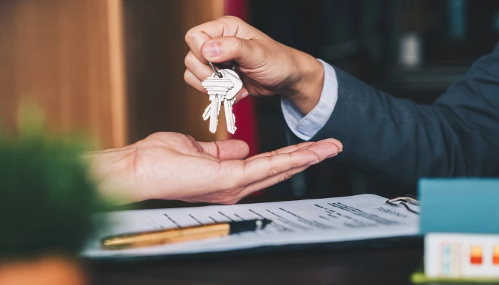Une personne remet ses clés à une autre personne